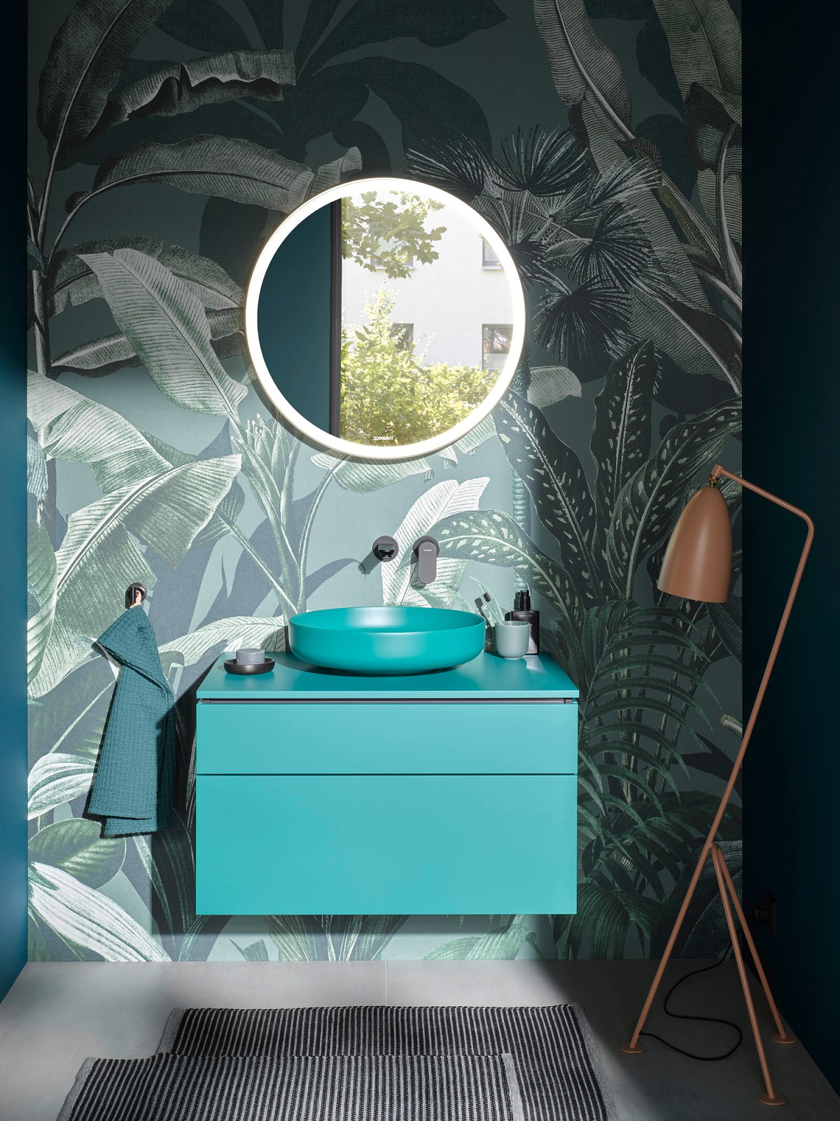 blue-green wall hung vanity against palm tree patterned wallpaper