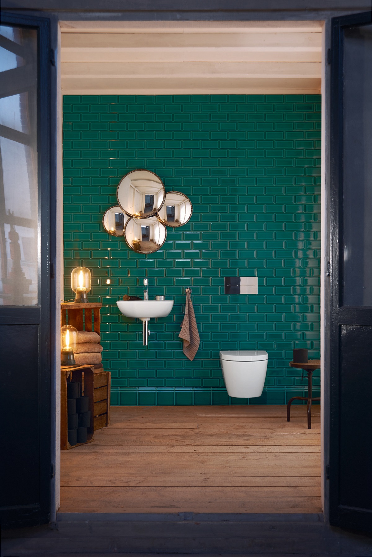 dark green bathroom wall tiles contrast with white fittings