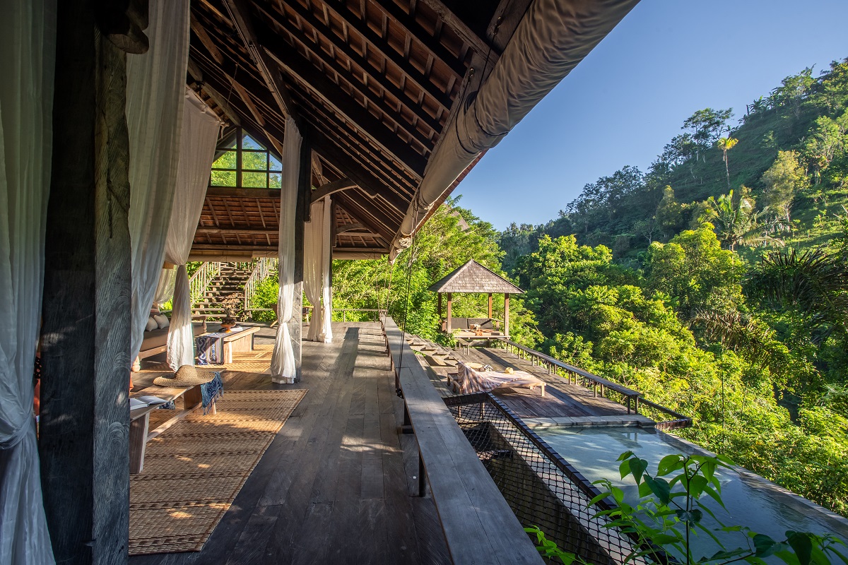 The main lobby area of Buahan, A Banyan Tree Escape, Bali looks out over the pool deck and surrounding landscape