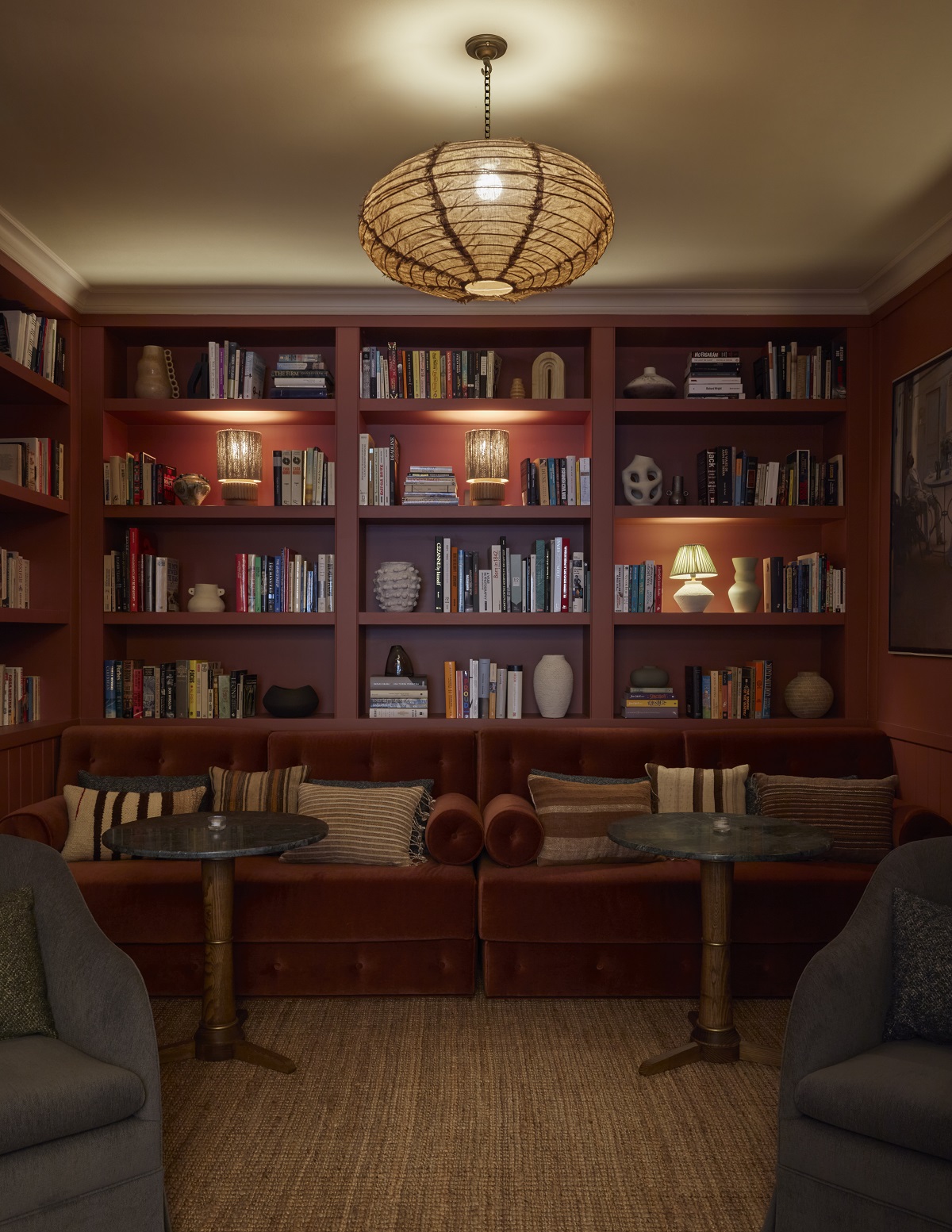 seating, low lighting, books and cocktails in the library at Borneta