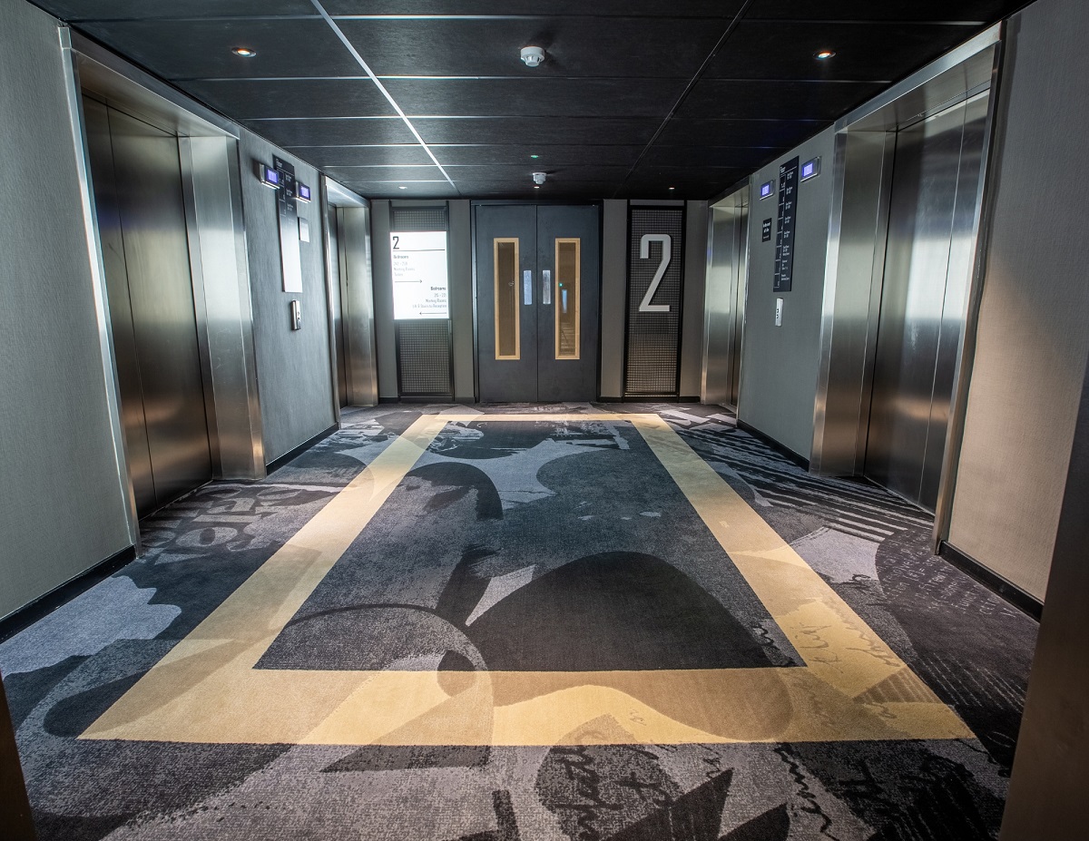 grey and silver patterned carpet in hotel passage by Balsan