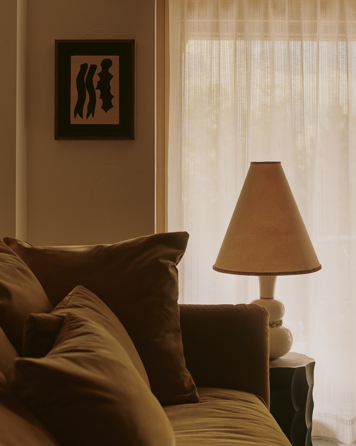 couch and cushions with light and art in common space of the Brecon hotel