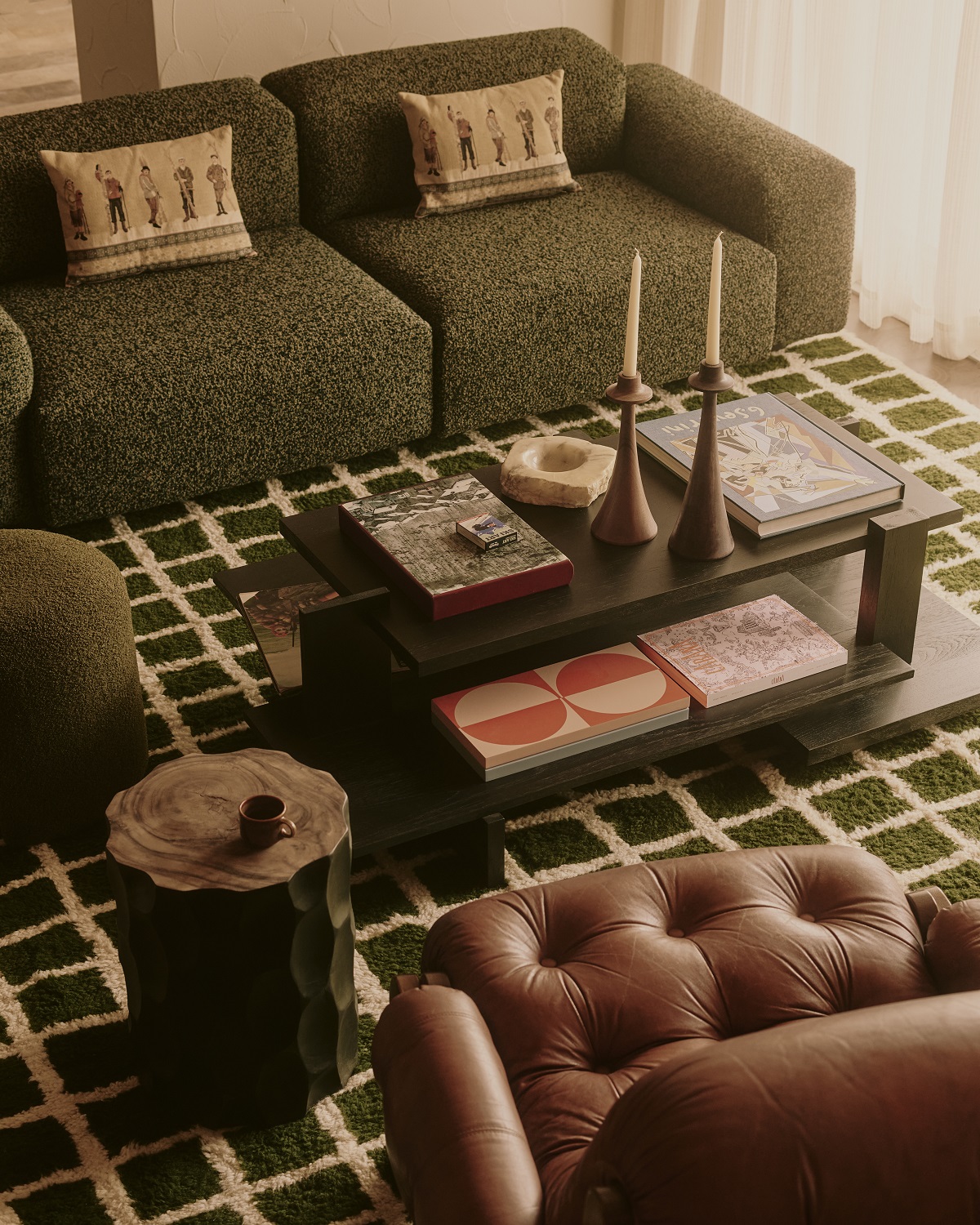 view from above of leather chair and coffee table on green carpet