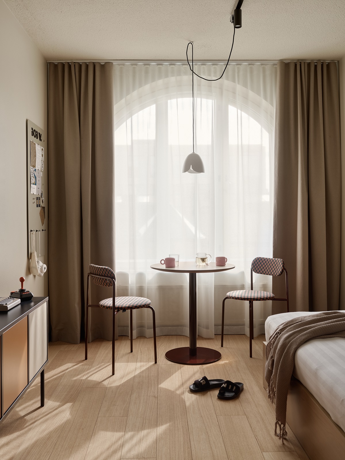 table and chair in front of window in the guestroom