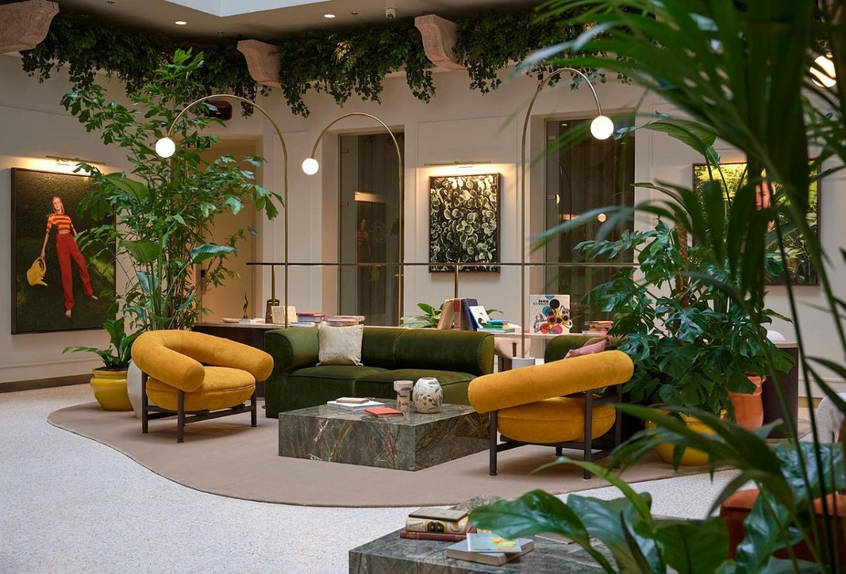 central seating area in lobby surrounded by plants in Verno House Budapest