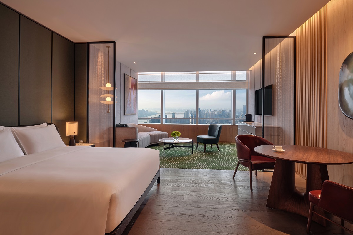 The guestroom showcases the hotel's height with views across the city