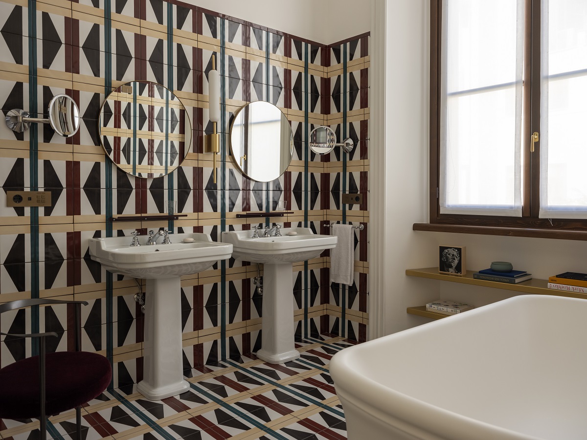 bathroom design with pattered tiles on the floor and up the wall