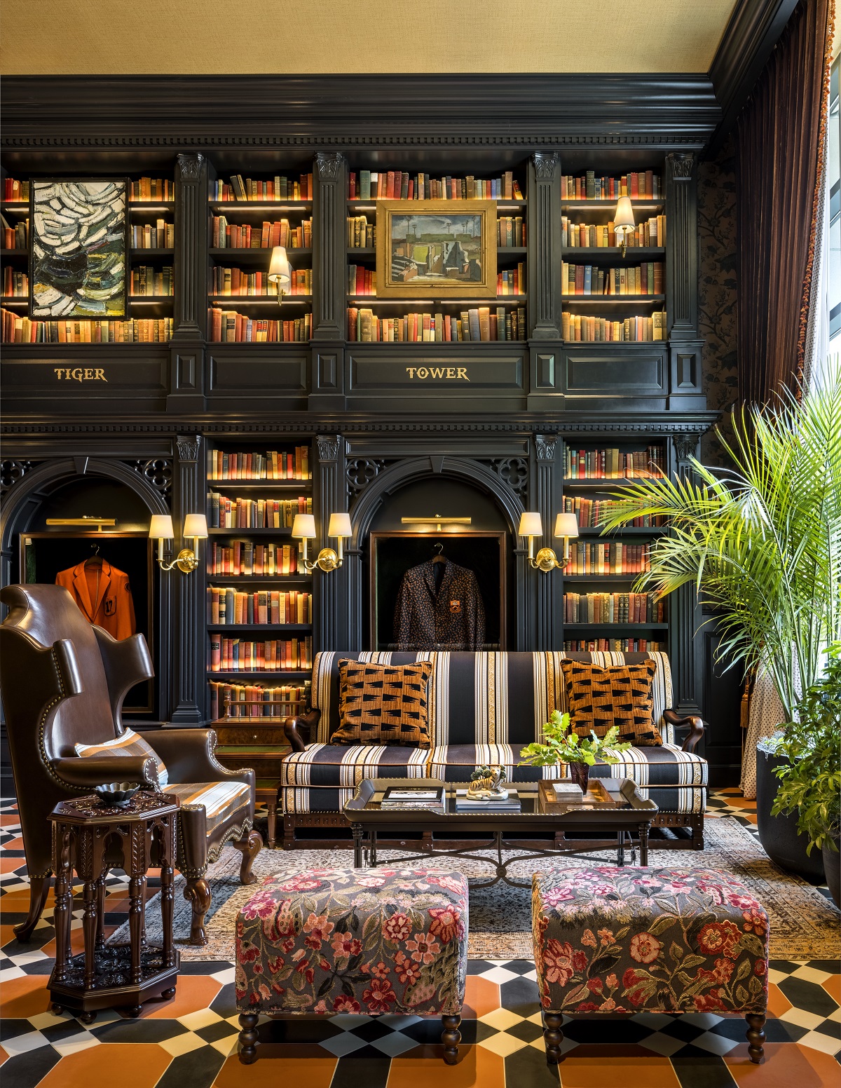 lobby with checked floor, patterned furniture and library shelving