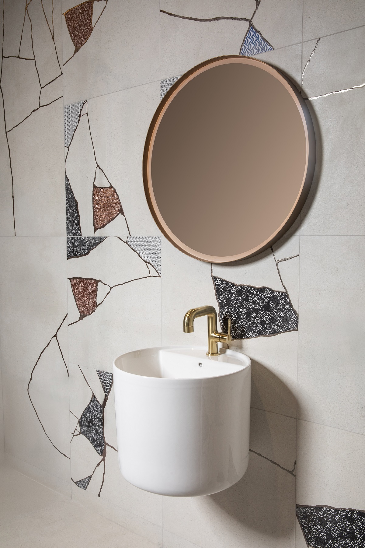 round mirror above round wall hung basin