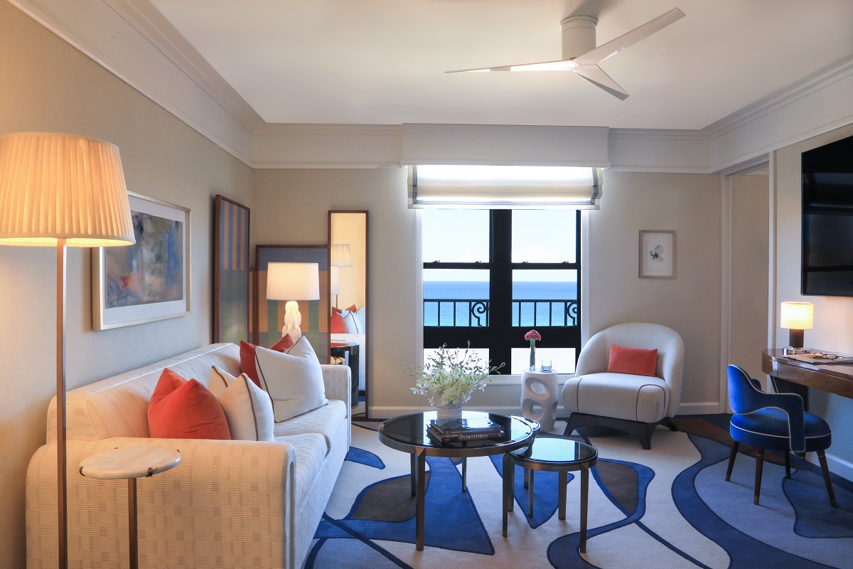 seating on bespoke blue patterned carpet in guestroom with ocean view