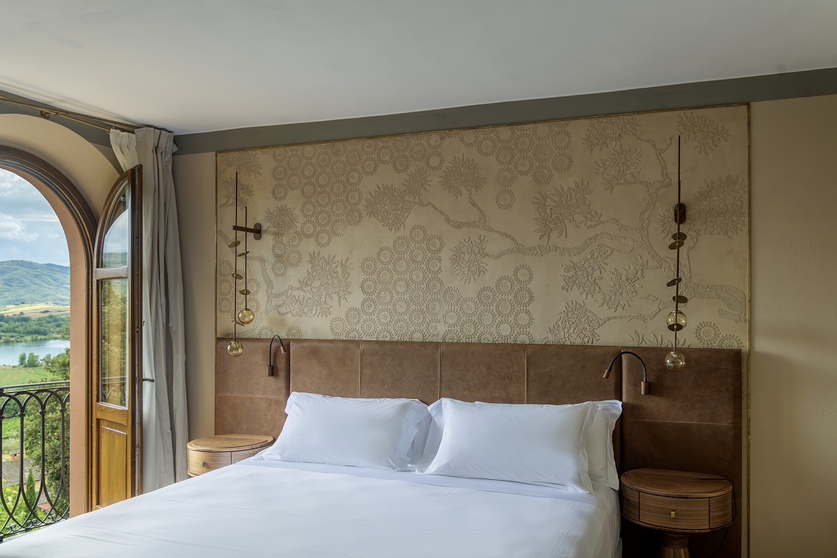 terrace suite guestroom with window and balcony over umbrian countryside