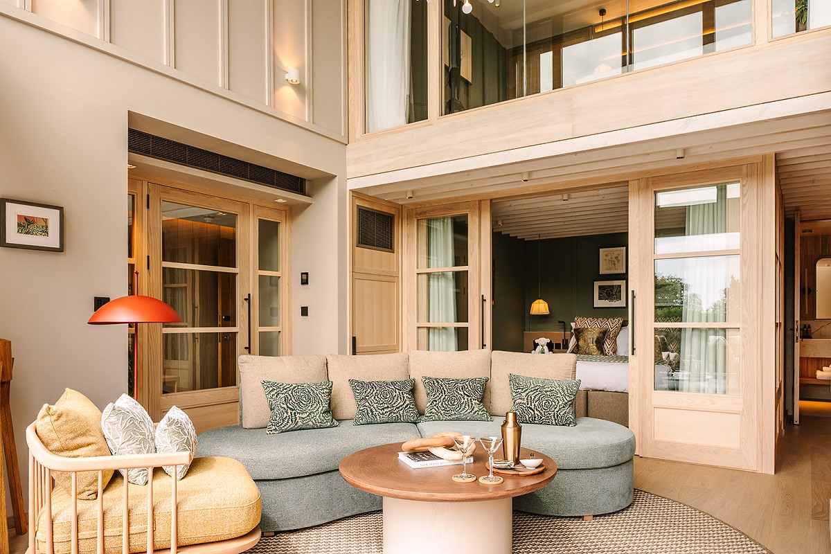 interior of double volume cabin at The Reeds with decor in wood, natural materials and shades of green