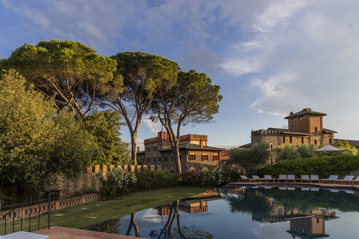 view across swimming pool to hotel at Borgo dei Conti Resort