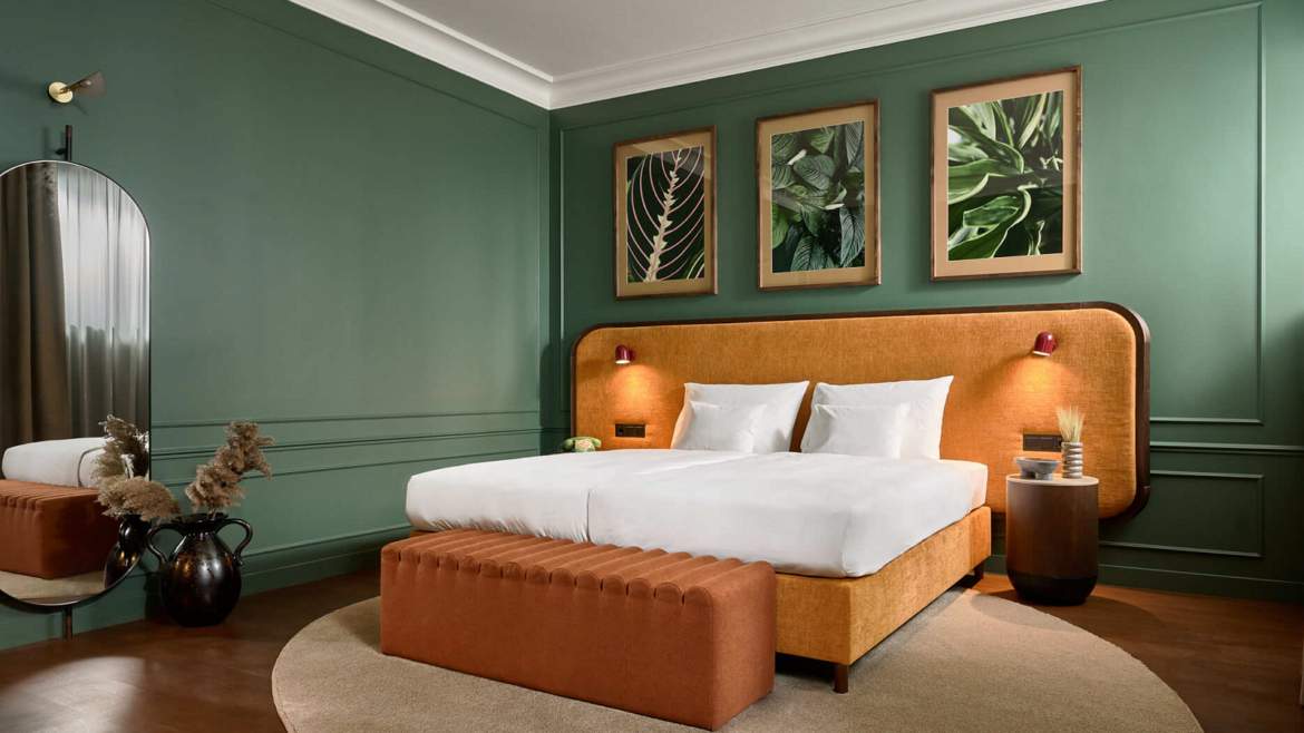 green walls and terracotta headboard in guestroom at Verno House Budapest