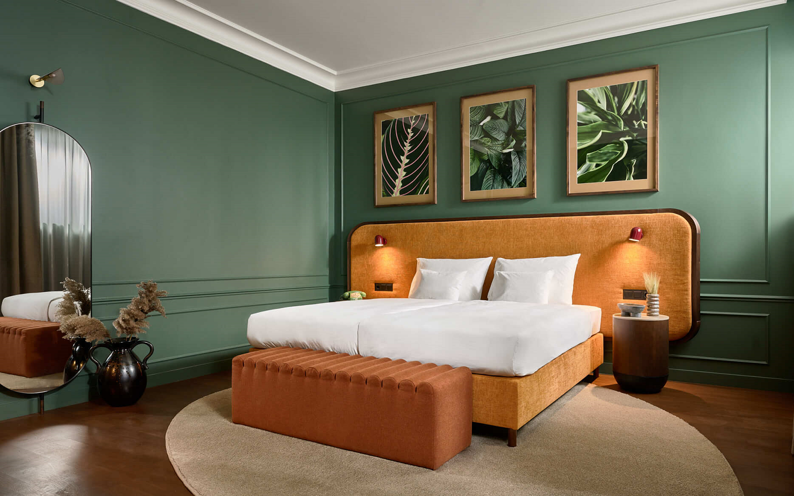 green walls and terracotta headboard in guestroom at Verno House Budapest