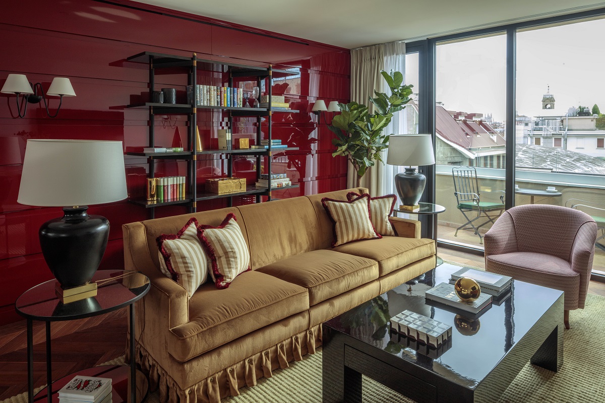 red walls and mustard couch in lounge with view over Milan