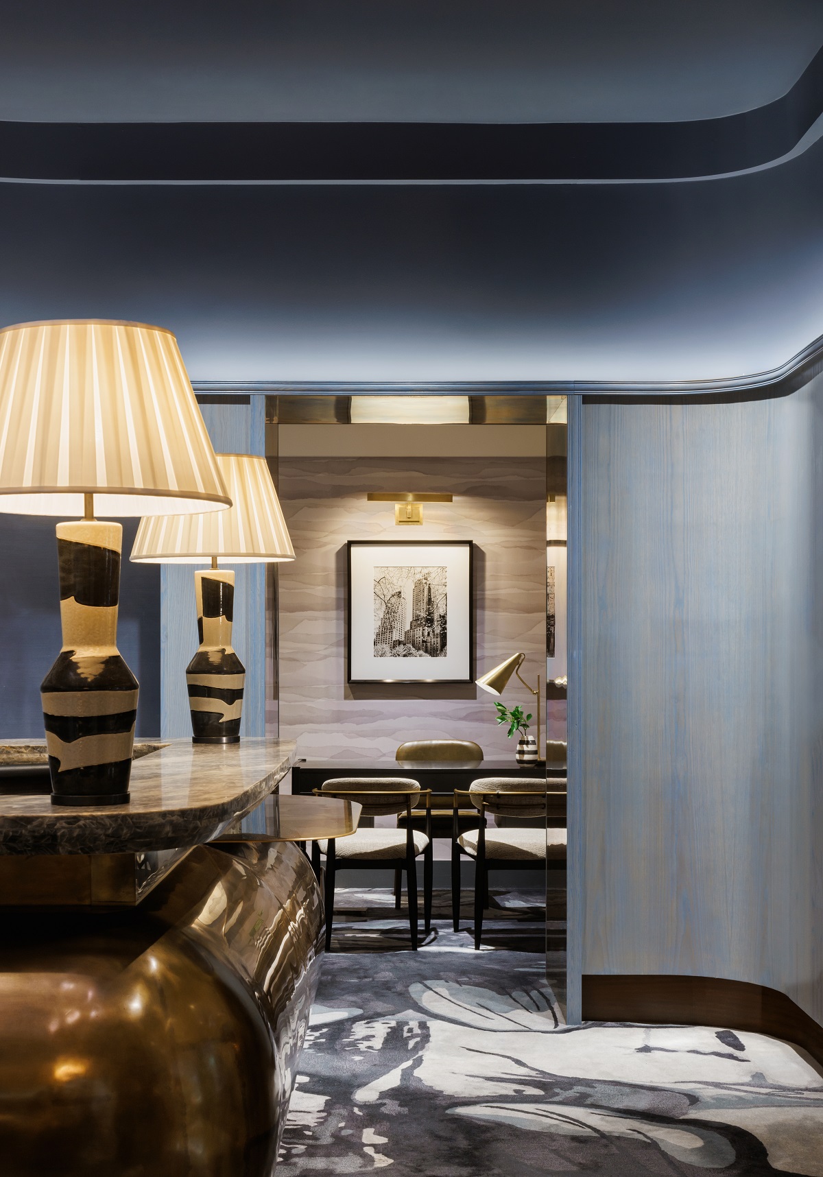 curved reception desk and curved blue walls in reception of JW Marriott Essex House