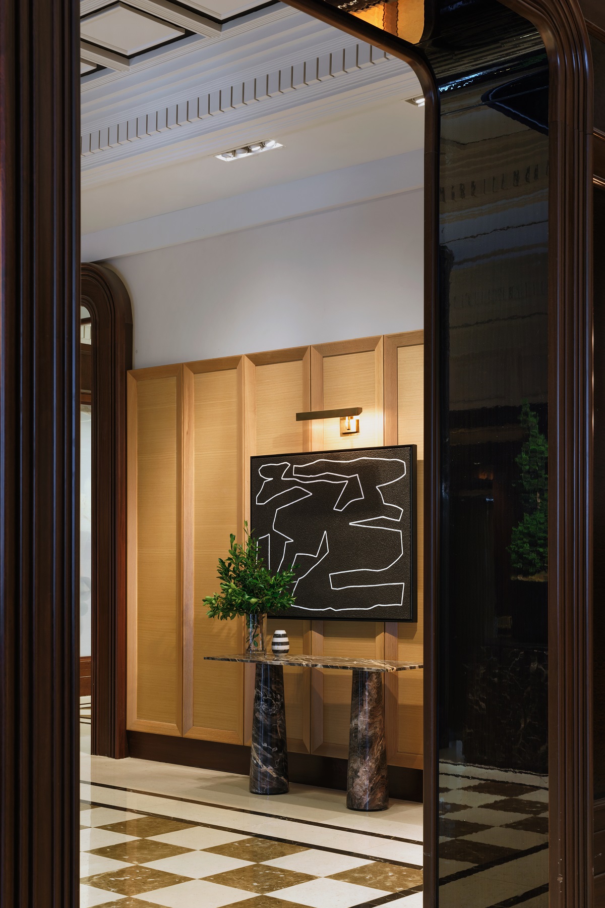 view into JW Marriott Essex House hallway with checked floor and panelled walls