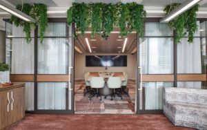 entrance to Accor head office meeting space with hanging plants and bespoke carpet from Modieus