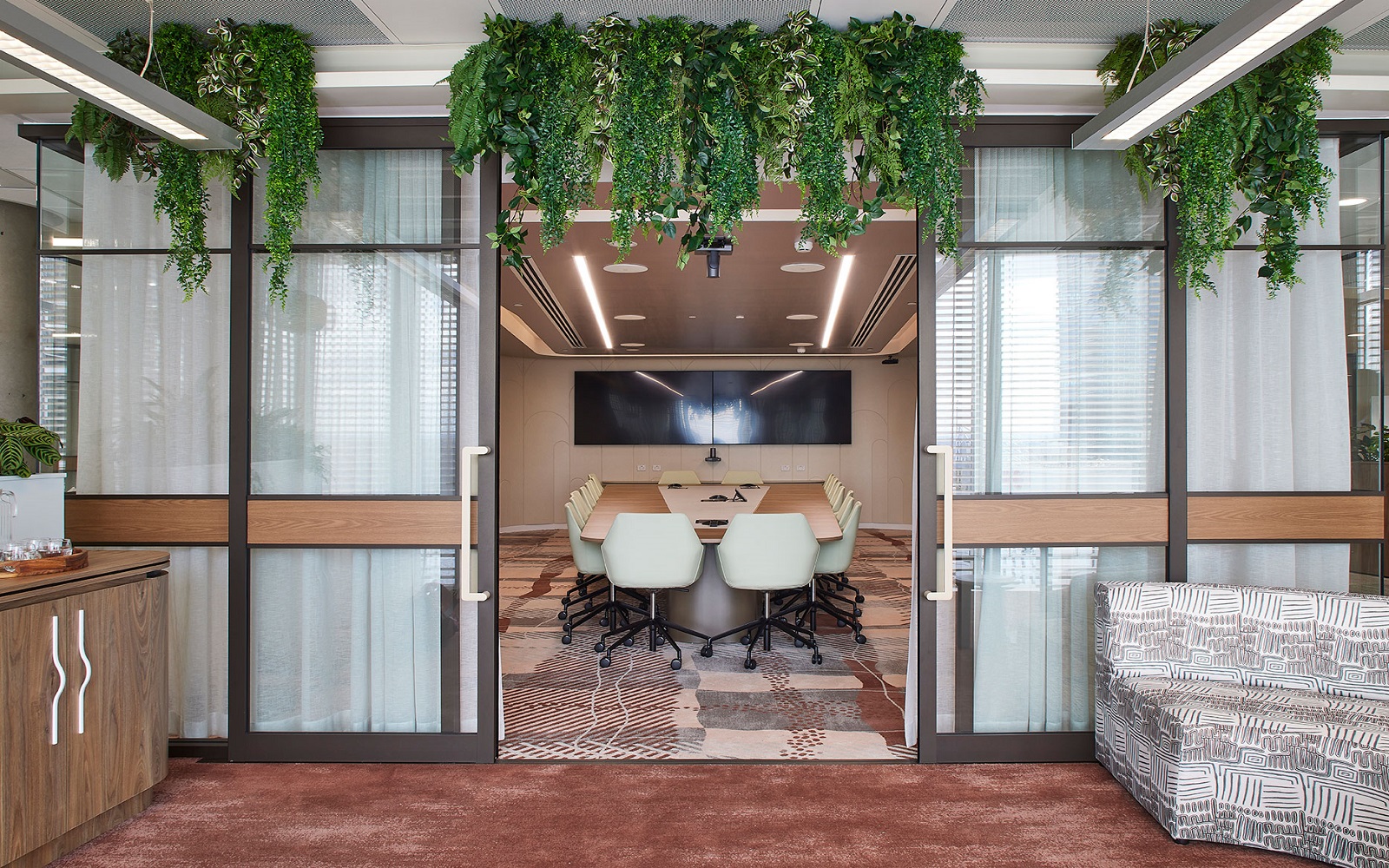 entrance to Accor head office meeting space with hanging plants and bespoke carpet from Modieus