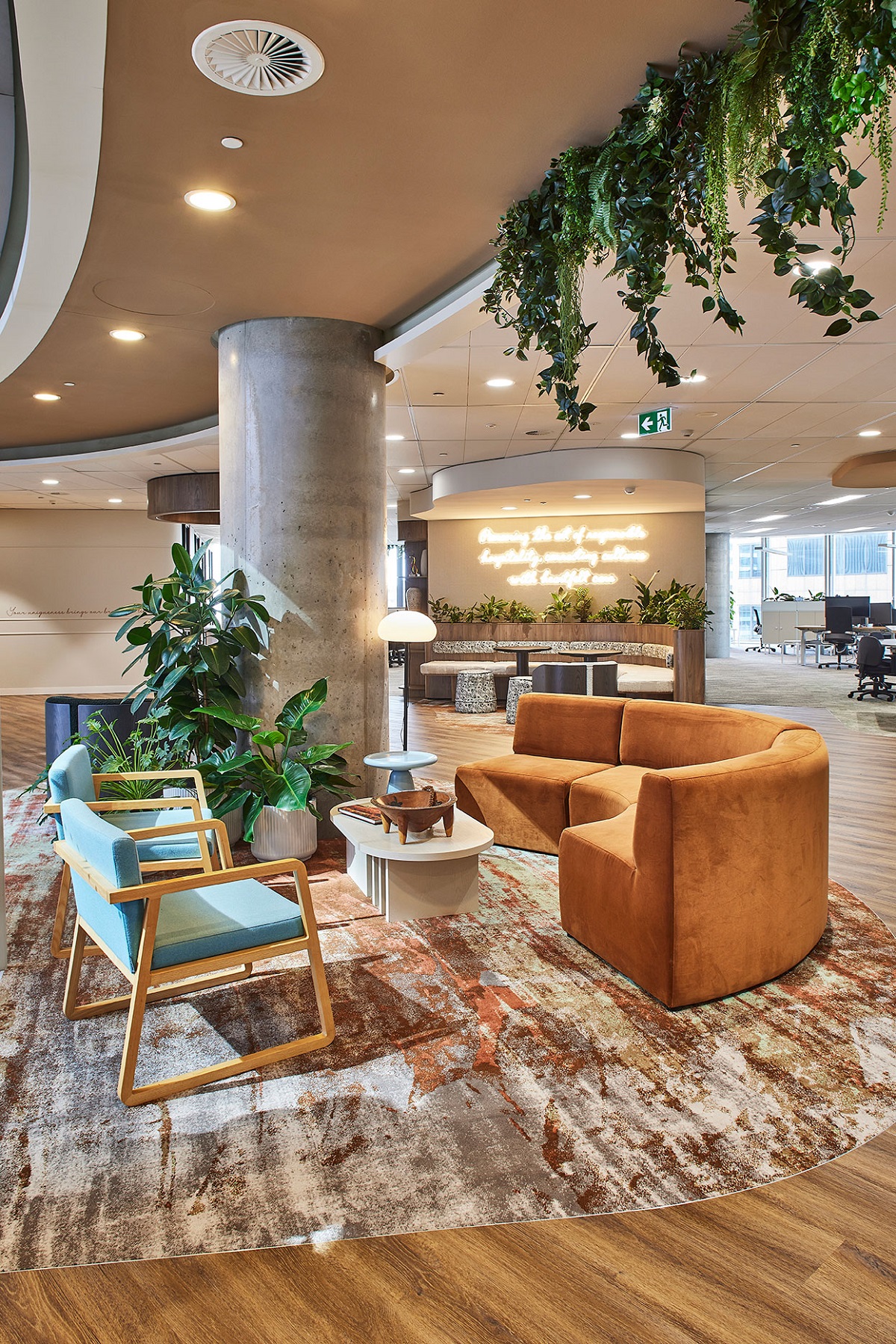 patterned Modieus carpet in circle under furniture in office with plants above