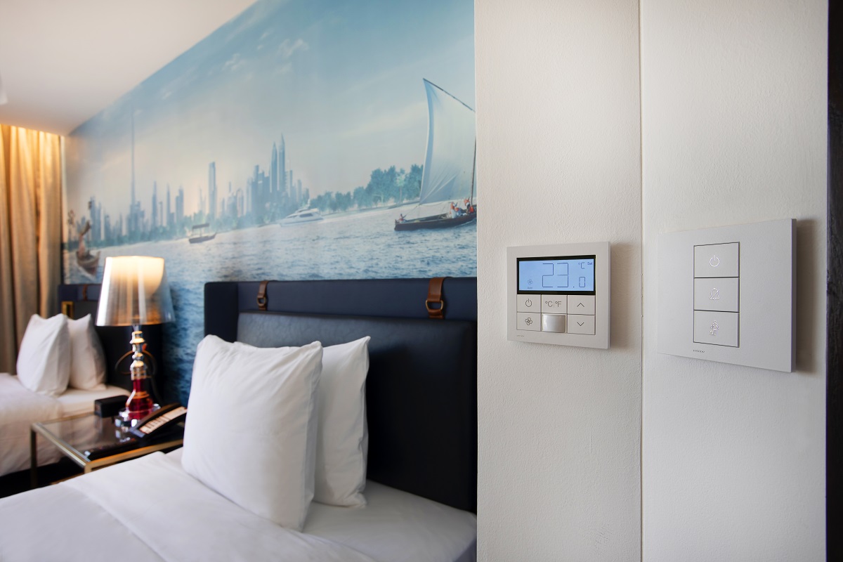 hotel indigo guestroom with control panels from Lutron