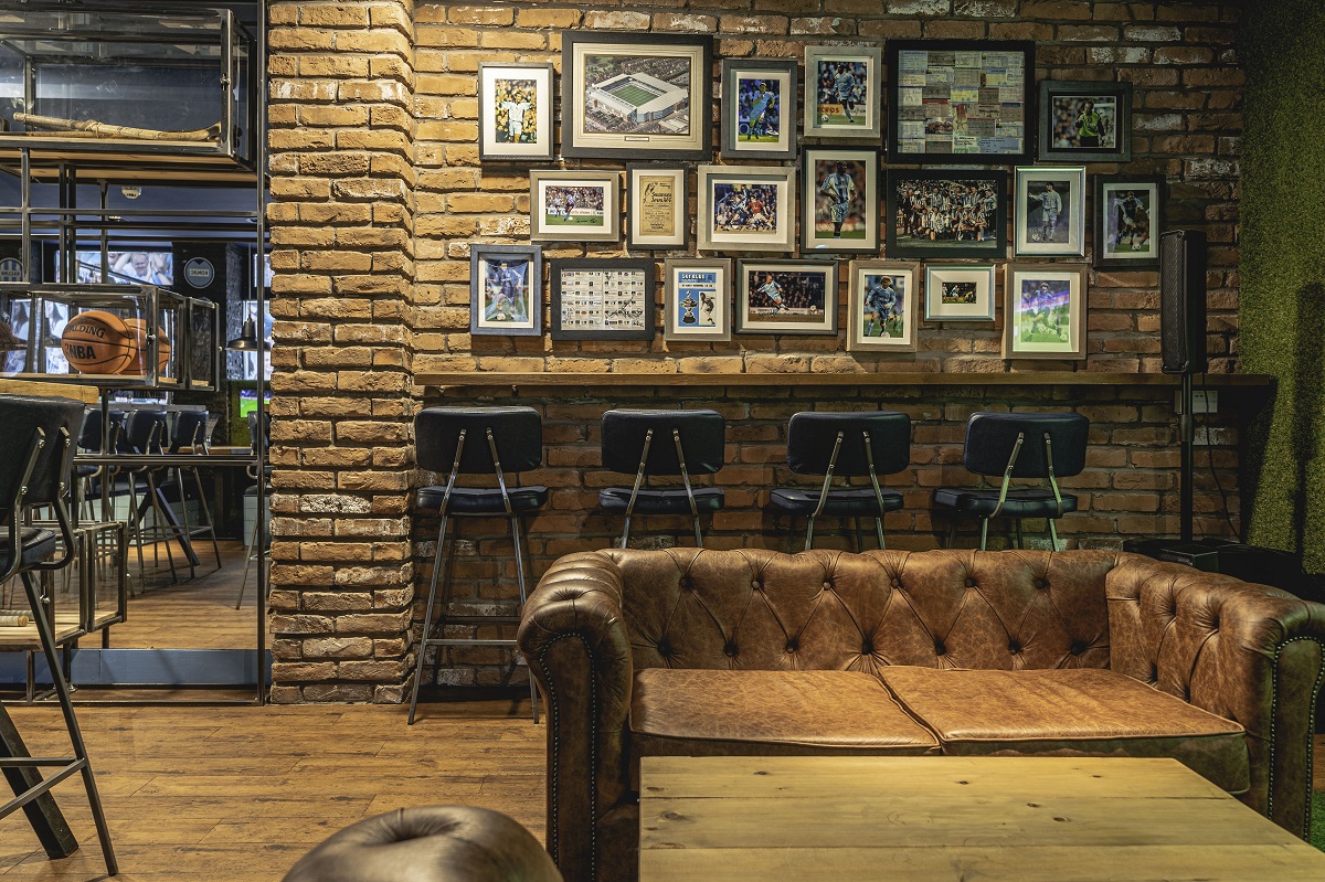 leather seating and a gallery wall in Sky Blue Tavern