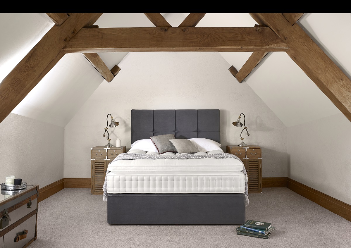 Attic bed under a beam with a Harrison Spinks mattress