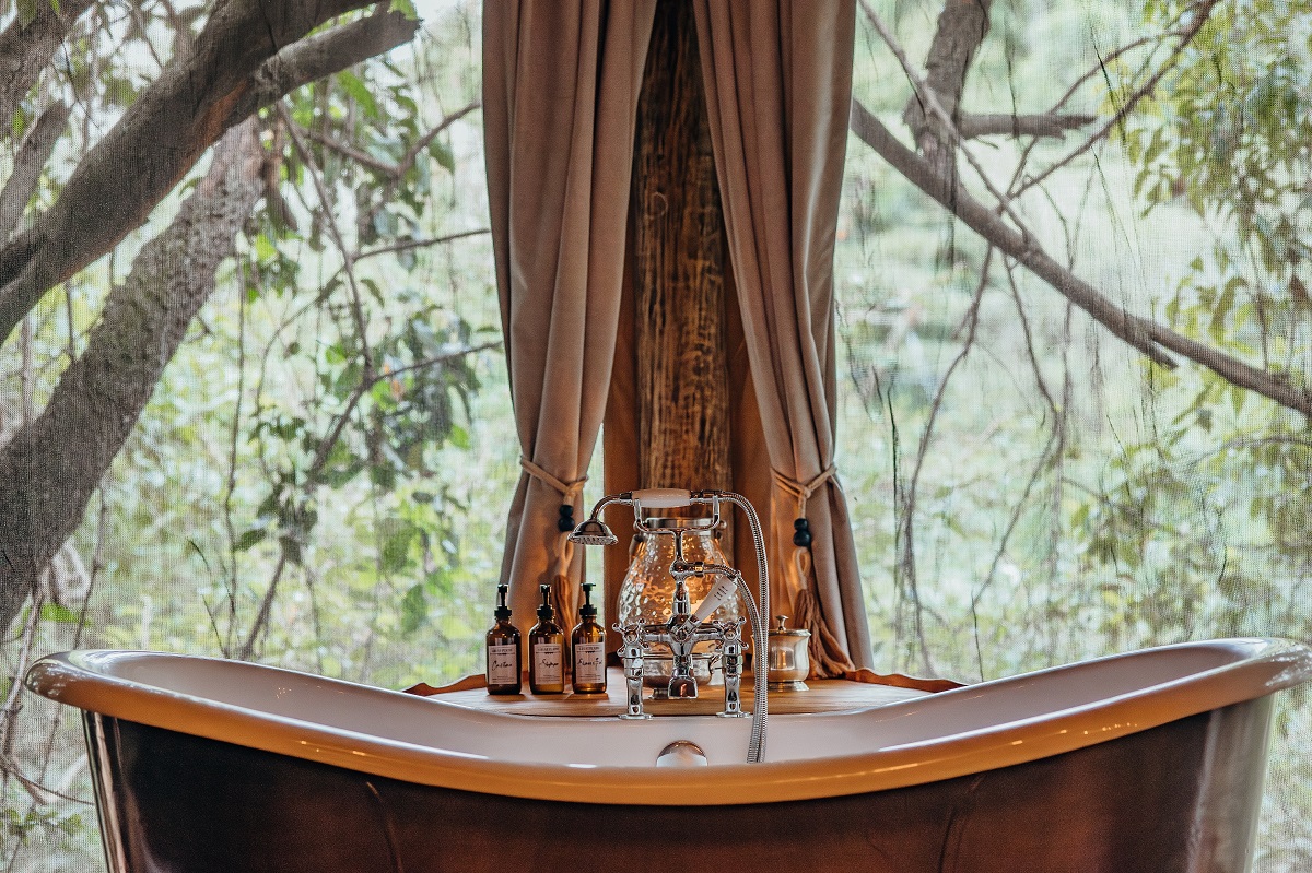 freestanding bath in tented guestroom in treetop tent