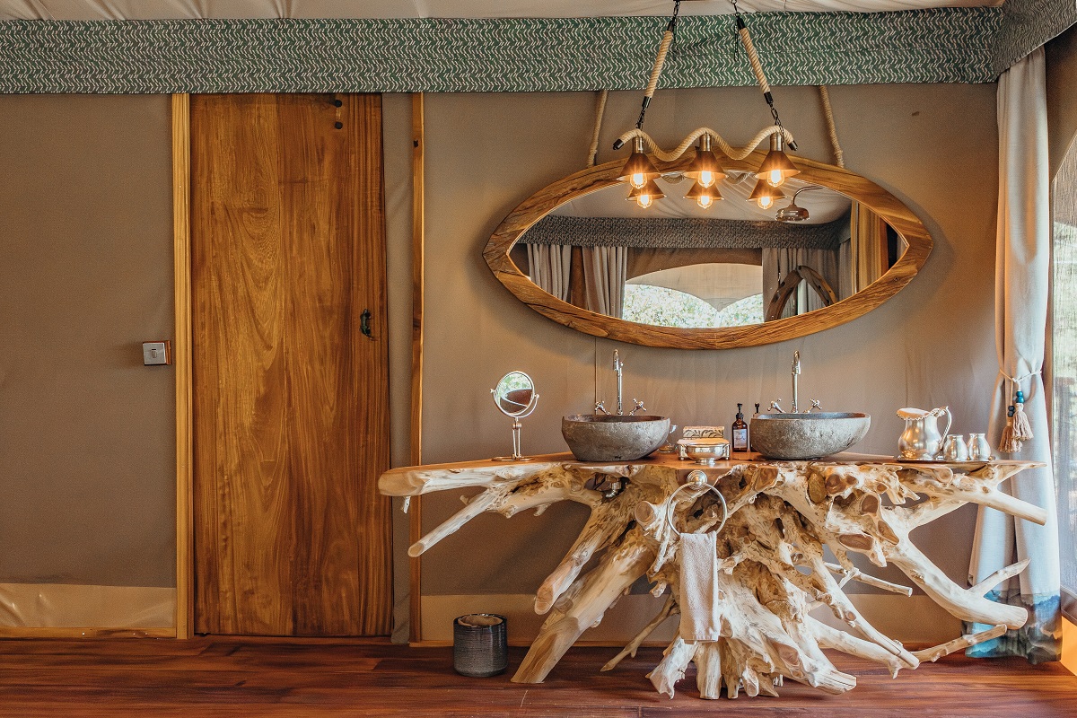 double basin on reclaimed driftwood vanity in safari camp bathroom