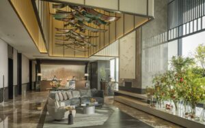 Four Seasons Hangzhou at Hanzhou Centre lobby space is a large are with huge double-height windows and polished stone flooring