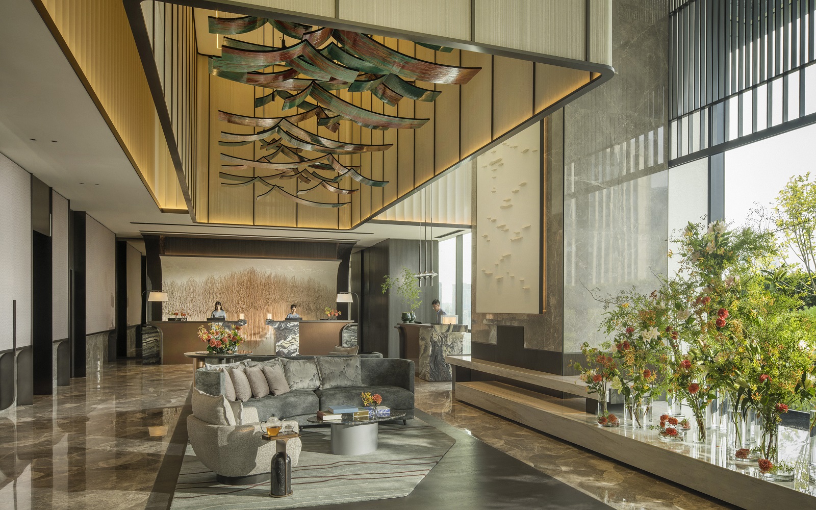 Four Seasons Hangzhou at Hanzhou Centre lobby space is a large are with huge double-height windows and polished stone flooring