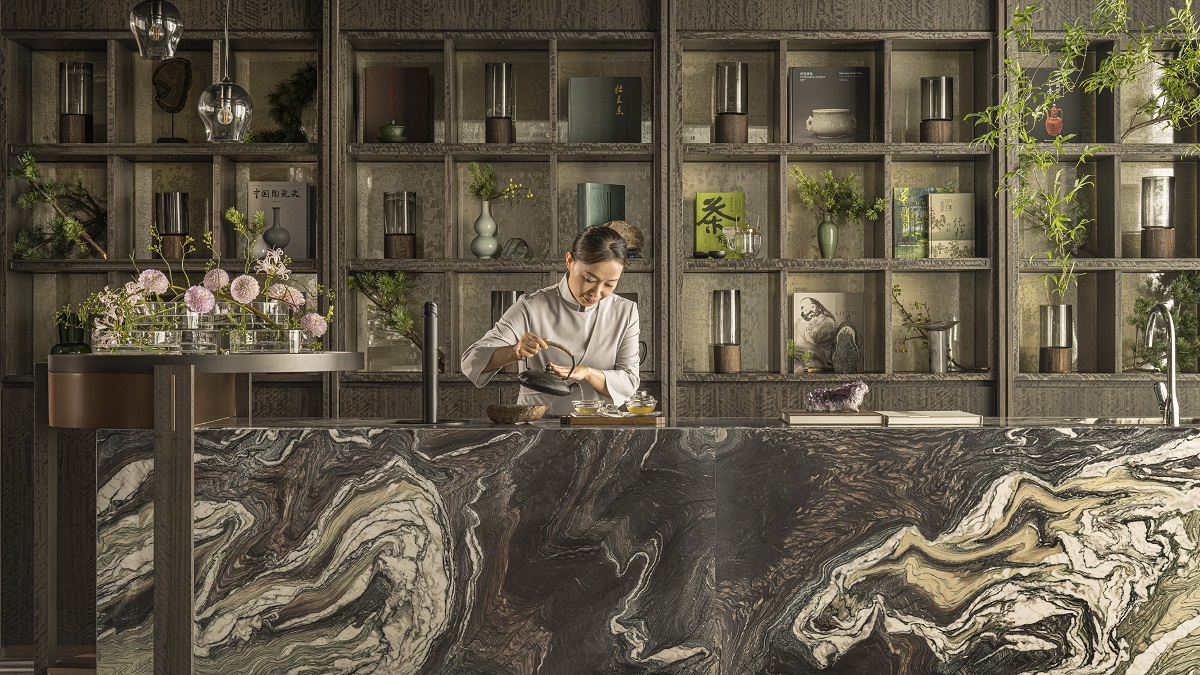 The hotel's bar is a soothing space with natural materials is darker tones including a large marbled bar