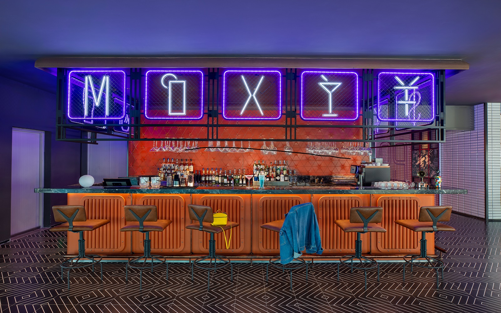 Moxy Bar in Chongqing with neon writing and orange tiled surfaces