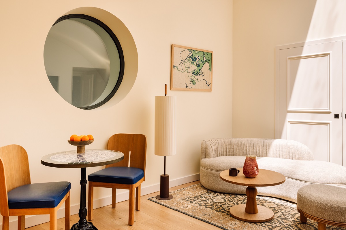 seating area in Locke Lisbon with art next to circular window