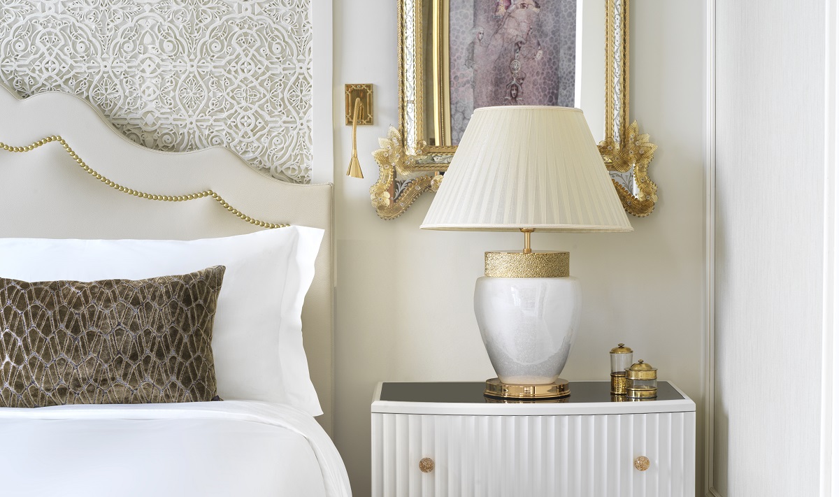 guestroom detail with moroccan carved headboard and white and gold design