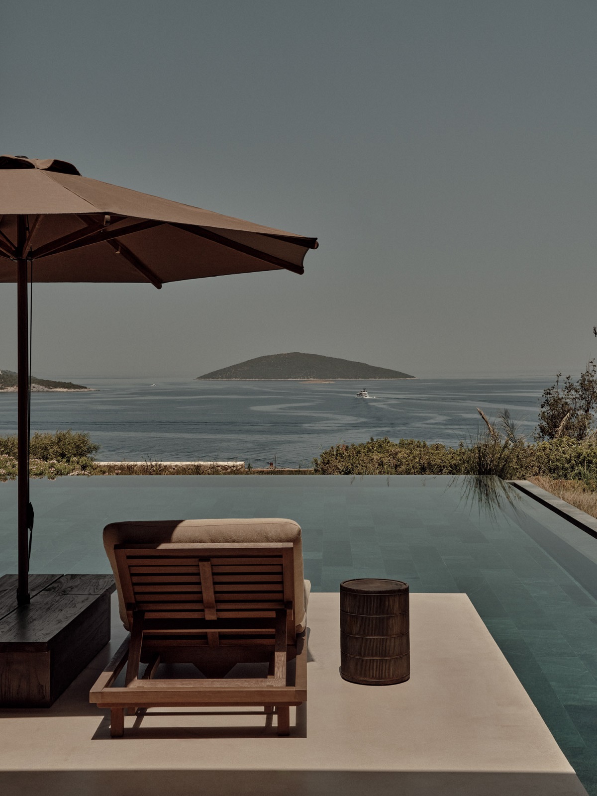 lounger, umbrella and infinity pool