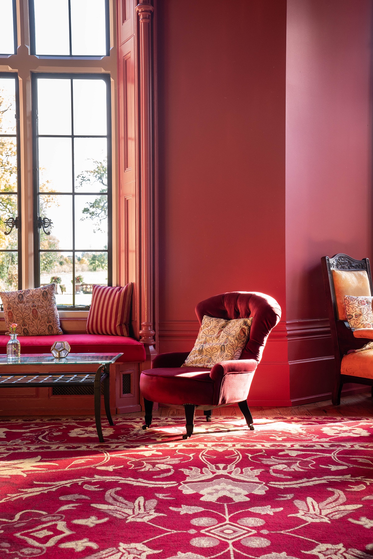 red walls , period architecture and furniture and bespoke Ege carpet at The Elvetham Hotel