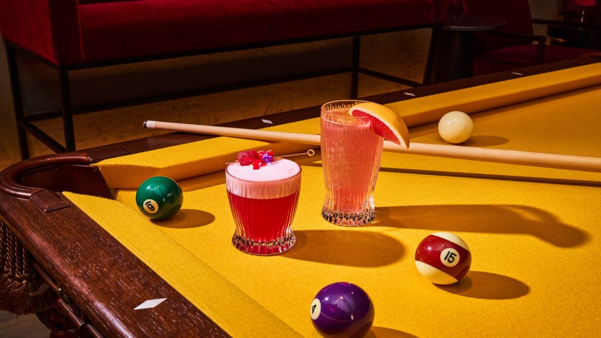 pink cocktails on a bright yellow pool table at Wonder Room Singapore