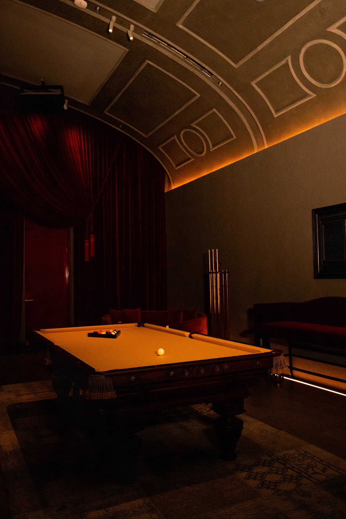 bright yellow pool table under a vaulted ceiling