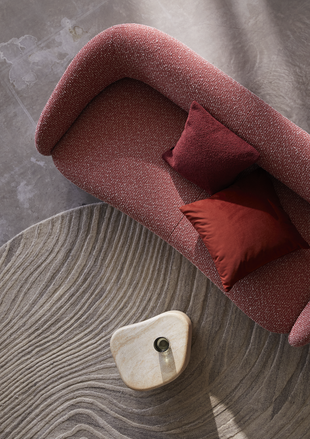 aerial view of pink couch on textured carpet