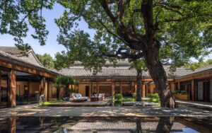 central courtyard at Mandarin Oriental Qianmen with tree and wooden deck