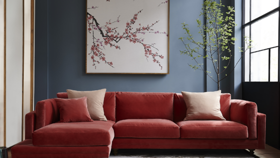 rose pink corner sofa against grey wall