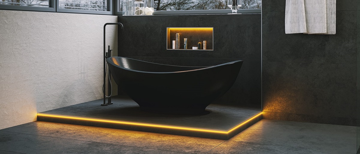 black freestanding bath on underlit platform