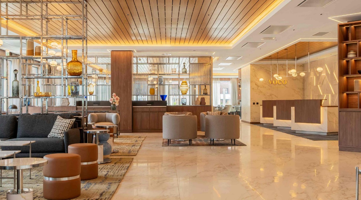 The lobby area of the hotel is a warm and welcoming space with lots of wooden elements and comfortable furniture