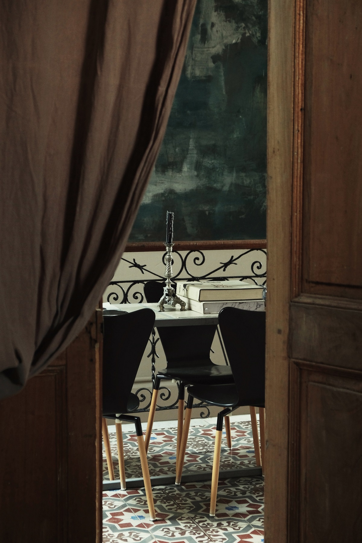 brown curtain pulled aside to reveal grand castle dining room