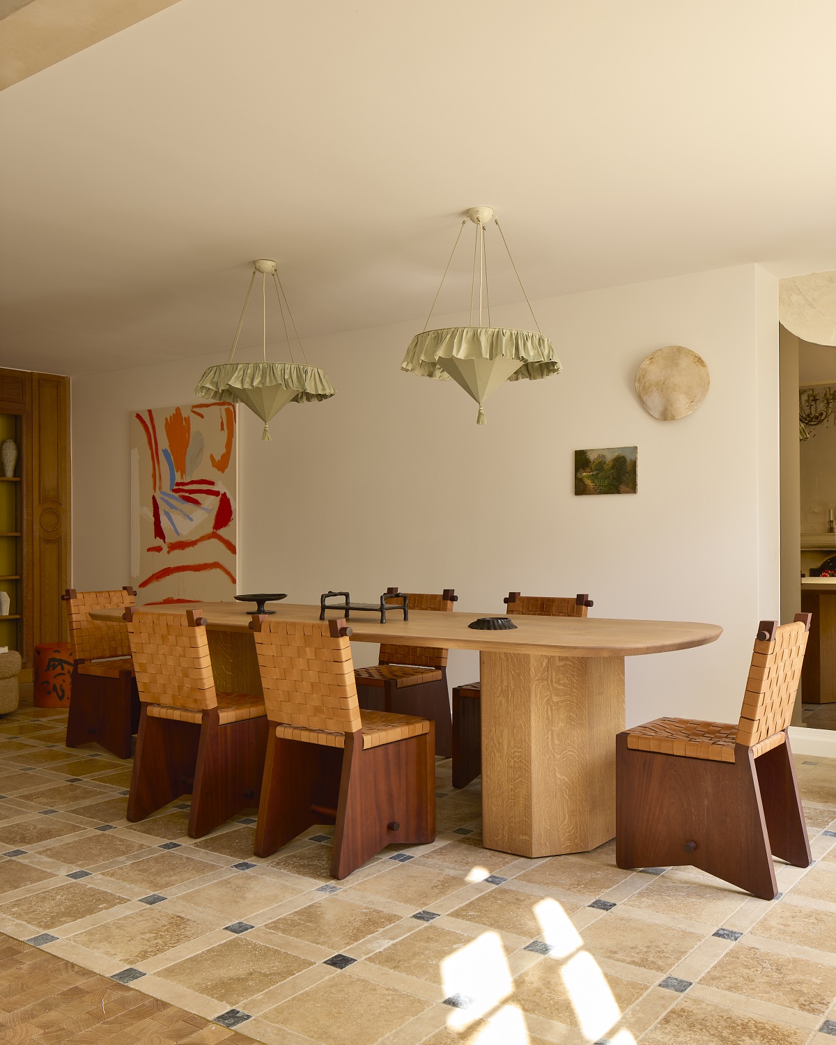 wooden table and chairs on tiled floor with fabric pendant lighting