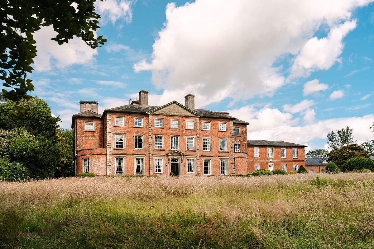 An exterior shot of Ansty Hall - a grand red-brick historic building