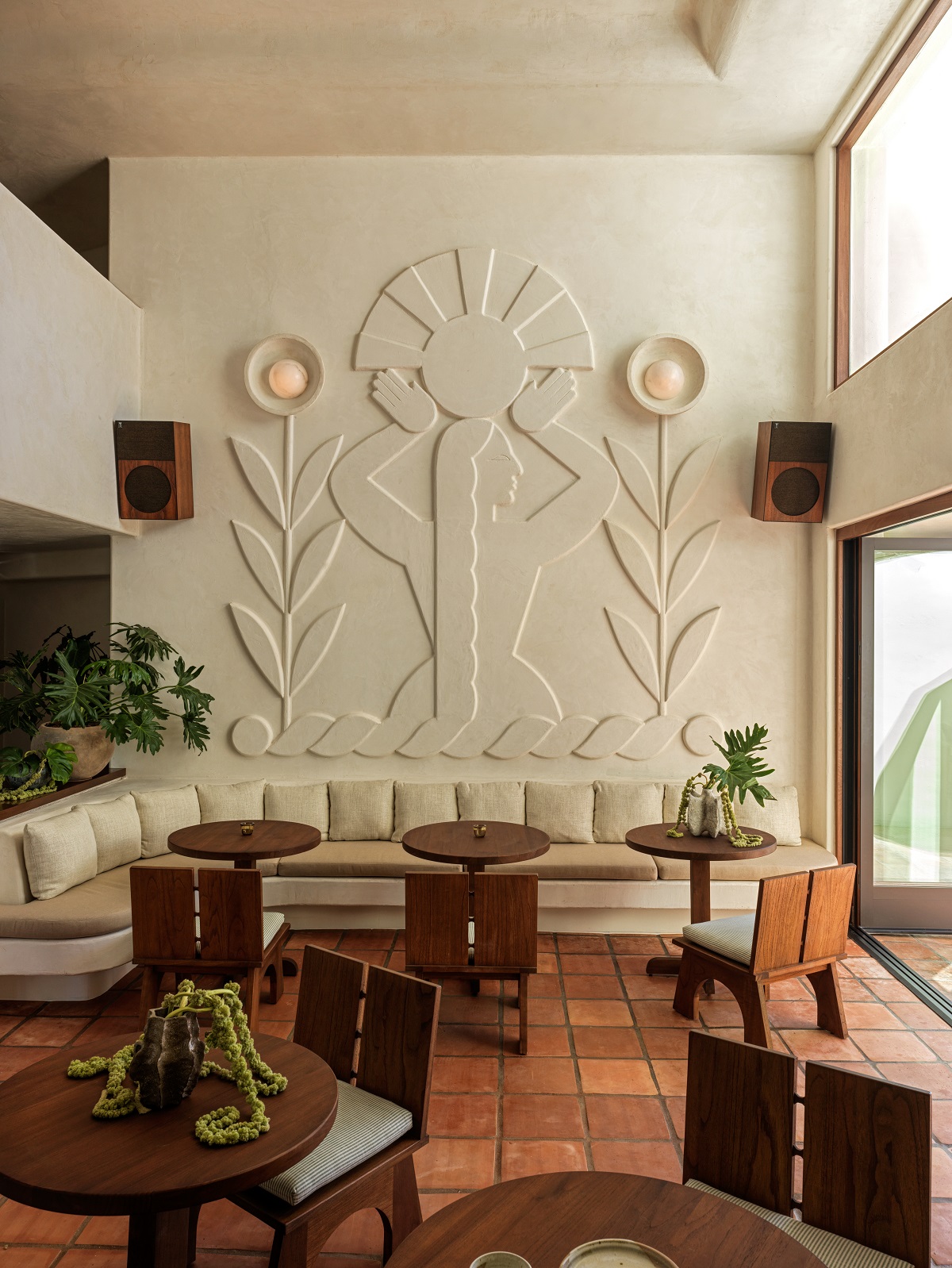 sculpted plaster wall mural above curved banquette style couch in Casa Loma