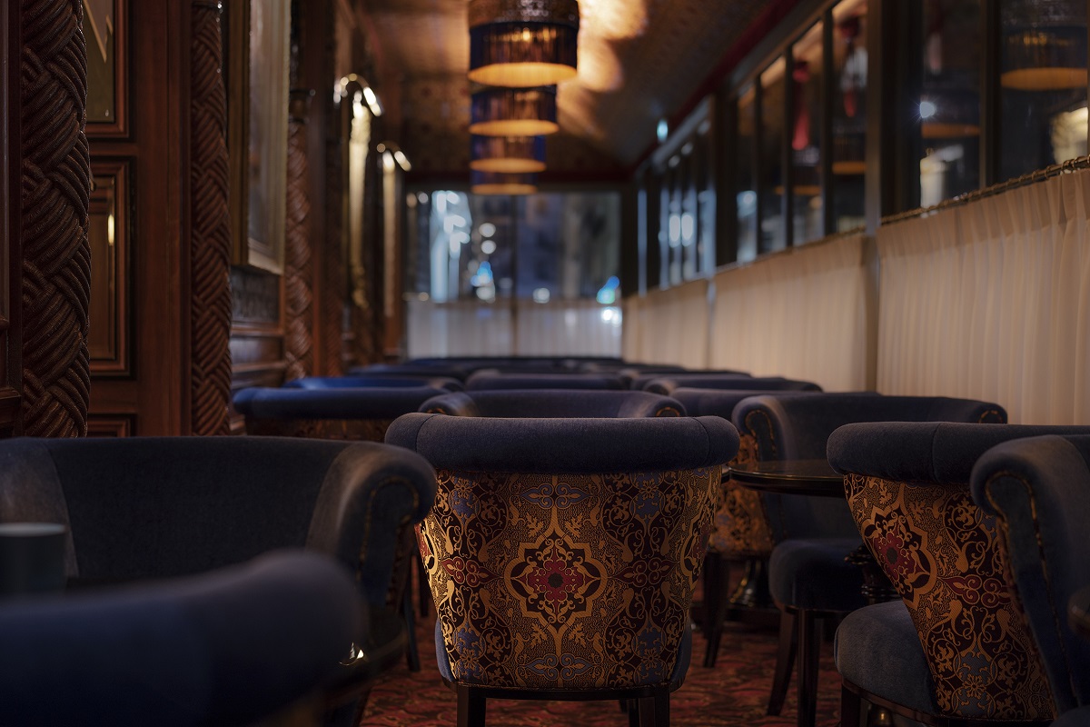 blue velvet chairs in the winter garden at Maison Proust Paris